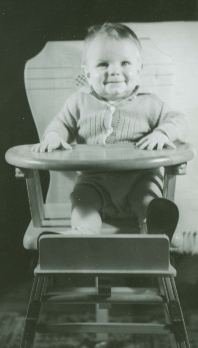 Smiling baby in high chair