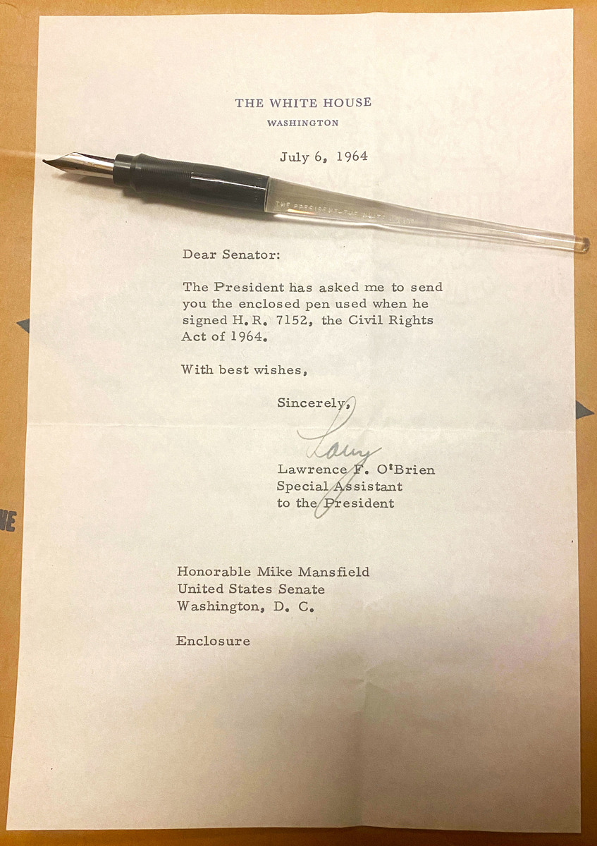 Clear plastic fountain pen used for the Civil Rights signing ceremony sitting atop a typed letter.