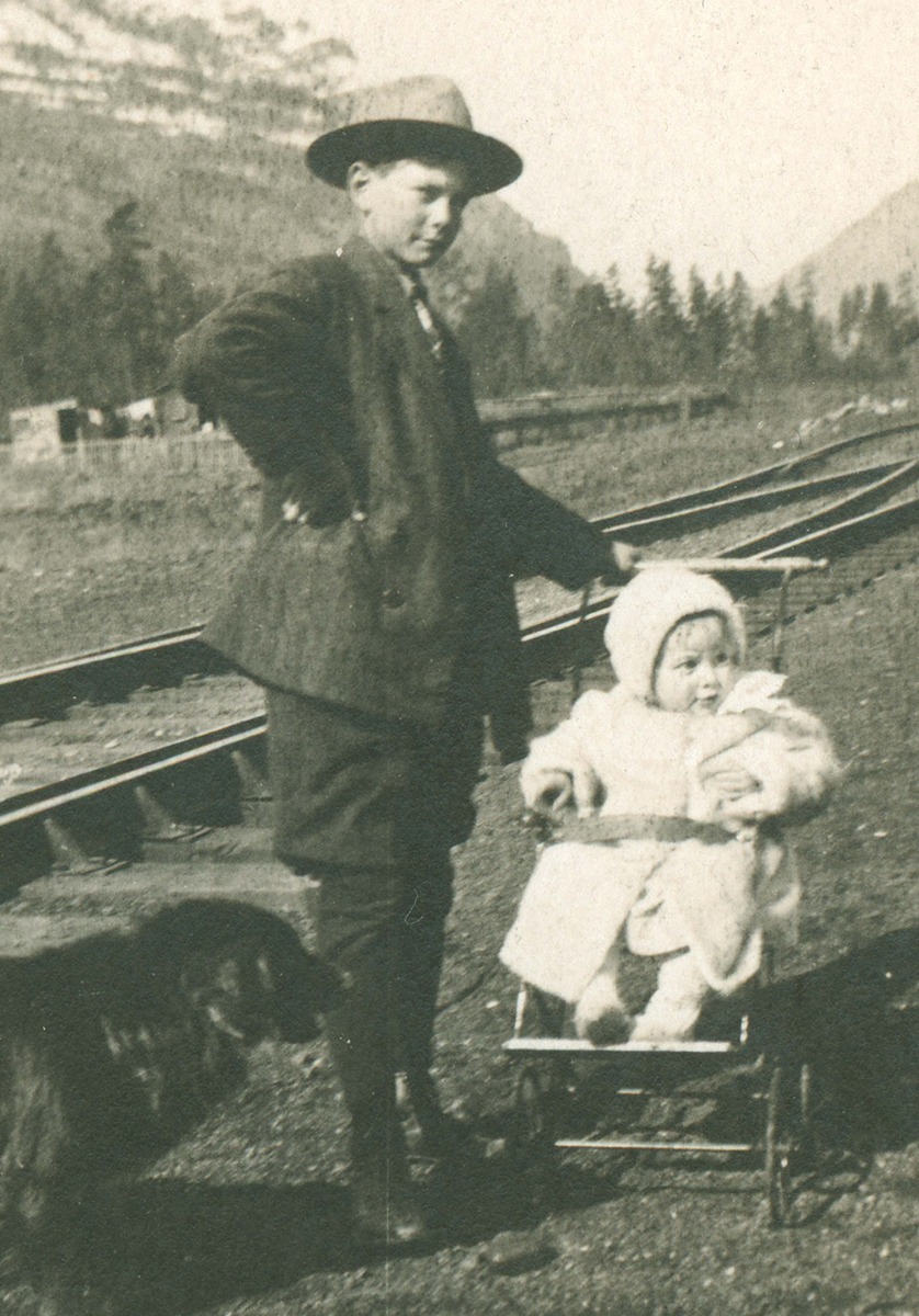 A boy with a baby in carriage
