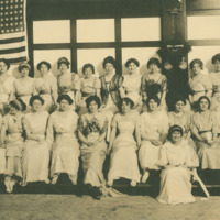 Kappa Kappa Gamma members in front of flag<br /><br />
