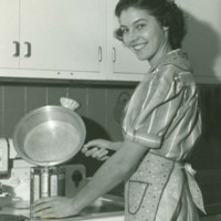 Woman pouring oil into a can.